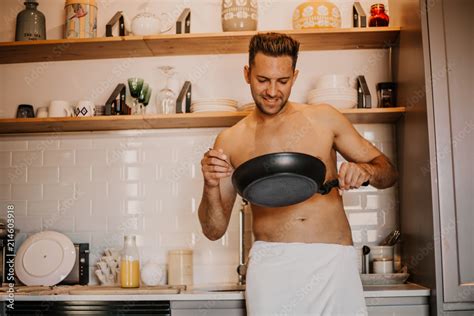 Sexy Chef With Naked Body Cooking In The Home Kitchen Stock Photo