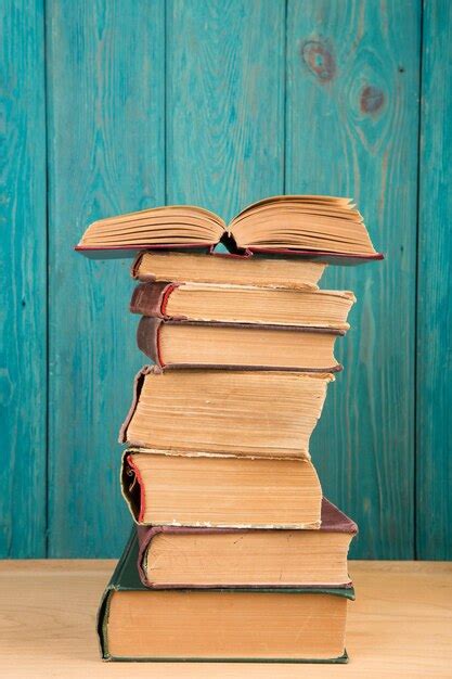 Premium Photo Stack Of Books On The Desk Over Wooden Background