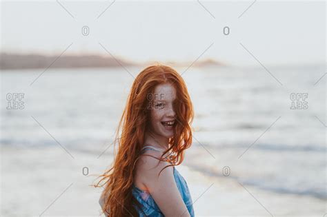 Redhead Teenage Girl Enjoying Morning At Beach Stock Photo OFFSET