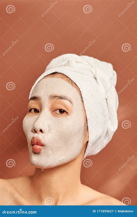 Beautiful Asian Woman Applying Facial Mask On Her Face Skin Care And Treatment Spa Natural