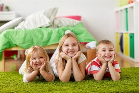 Happy Little Kids Lying On Floor Or Carpet Stock Photo Image Of