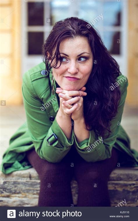 Download This Stock Image Woman Sitting With Mischievous Look Kj5110