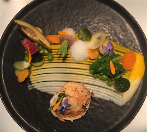 A black plate topped with different types of food