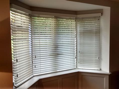 Wood venetian blinds for a bay window, supplied and installed by The