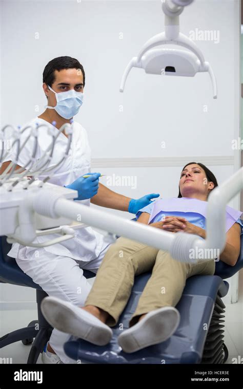 Dentist Treating Female Patient At The Clinic Stock Photo Alamy