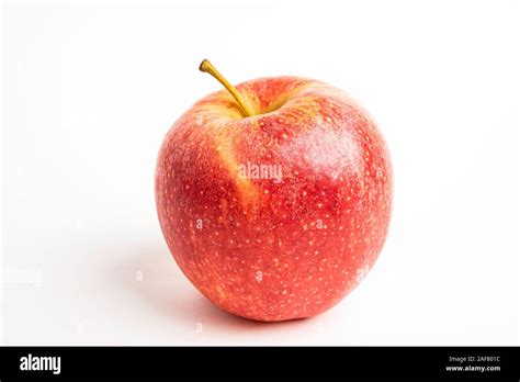 One Fresh Red Apple Isolated On A Plain White Background Stock Photo