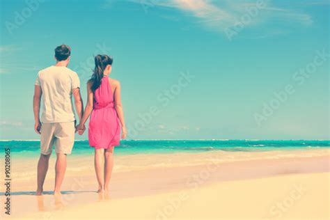 Couple Standing On Beach Travel Holding Hands Rear View Of