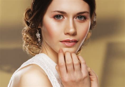 Close Up Of Beautiful Woman Wearing Shiny Diamond Earrings Stock Photo