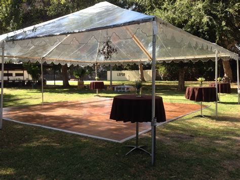 Tents, canopies and dance floors. The dance floor with a rustic chandelier to light up the ...