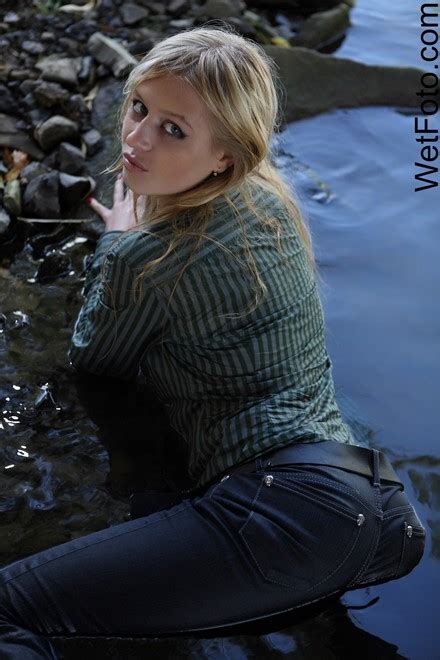 Wetlook By Beautiful Girl In Jeans Shirt And Shoes By The River Wetlook One