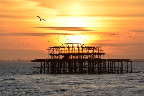 Sunset Over Old Brighton Pier As The Sun Goes Down The