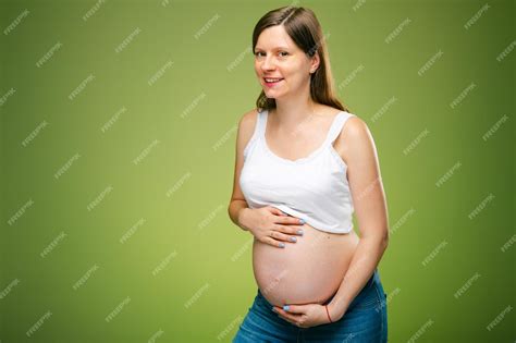 Беременная женщина с большим животом и счастливым выражением лица ожидая рождения ребенка