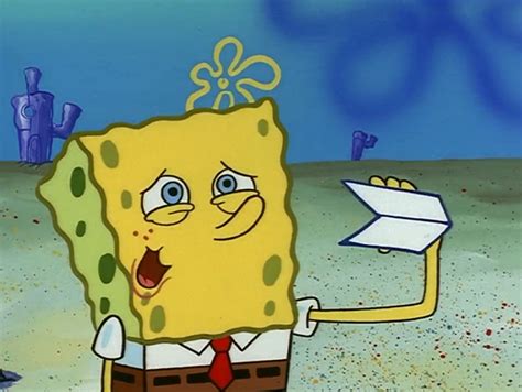 Spongebob Holding Up A Piece Of Paper In His Hand