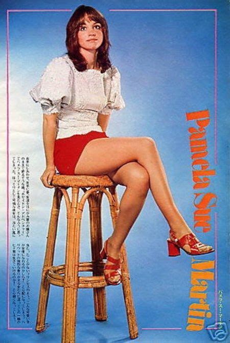A Woman Sitting On Top Of A Wooden Stool Wearing High Heeled Shoes And