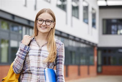 Portrait Of Female Student Standing Outside College Building Stock