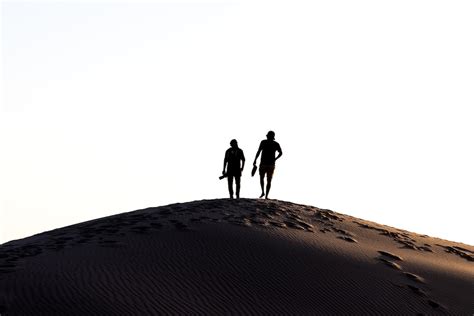 Two Person Walking On Desert Photo Free Sand Image On Unsplash