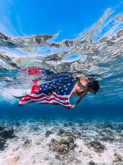 Woman With Mask Swimming In Tropical Ocean With Us Flag Independence