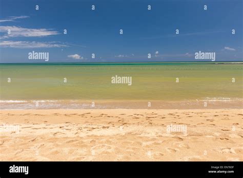 Beach On Tropical Island Clear Blue Water Sand Clouds Stock Photo
