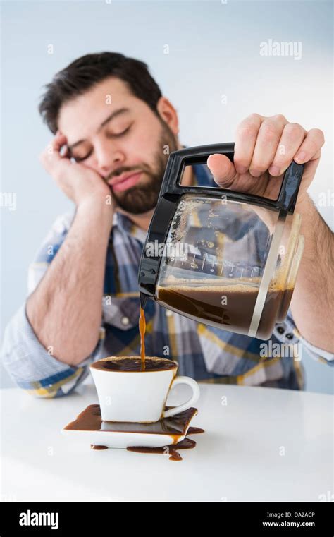 Tired Sleepy Man Spilling Coffee On Table Stock Photo Alamy