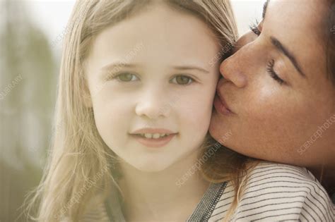 mother kissing daughter s cheek stock image f013 4876 science photo library