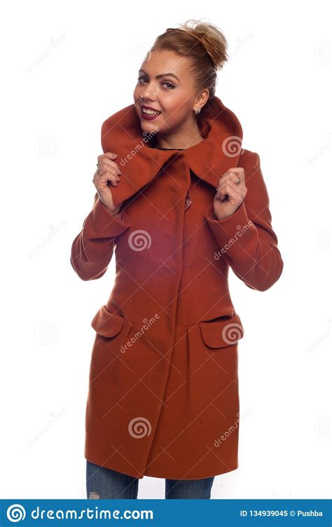 Blonde In A Red Coat With A Large Collar And Pockets Stock Image