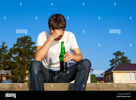 Sad Young Man With A Beer On The Street Stock Photo Alamy