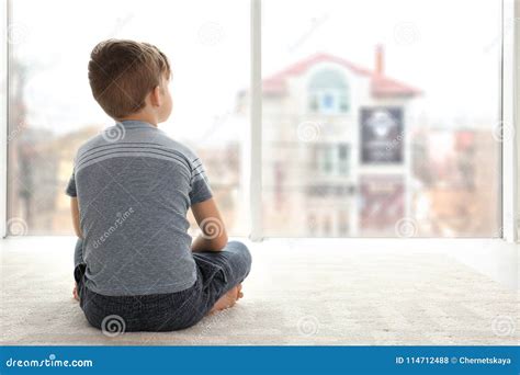 Lonely Little Boy Sitting On Floor In Room Stock Photo Image Of Floor