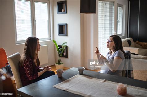 Beautiful Deaf Women Enjoying Coffee While Talking In Sign Language
