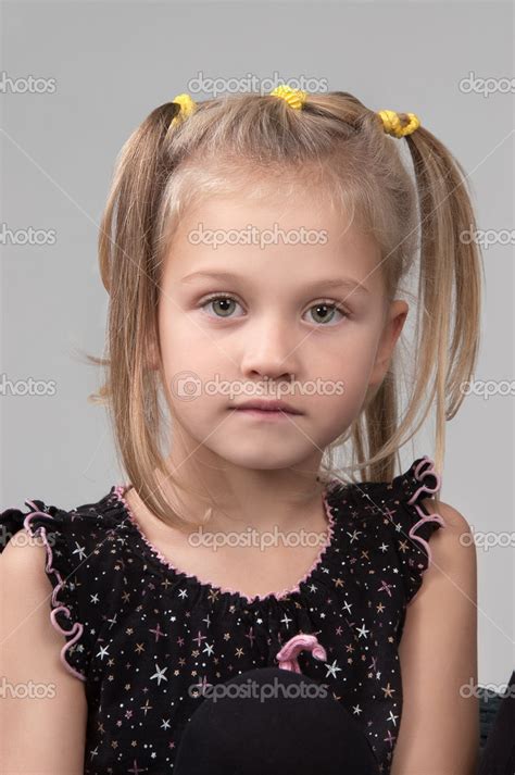 Adorable Sad Little Girl Looking At The Camera Stock Photo By ©voisine