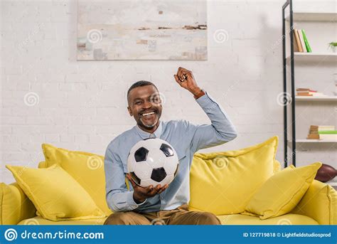 Cheerful African American Man Holding Soccer Ball And