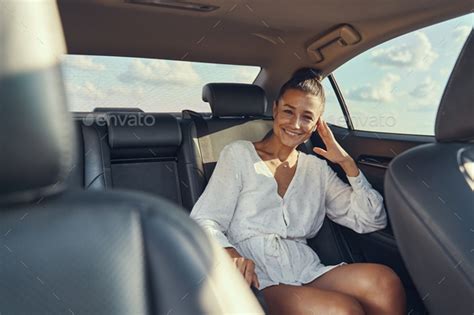 Woman Sitting On Rear Seat Of Automobile Stock Photo By Iakobchuk