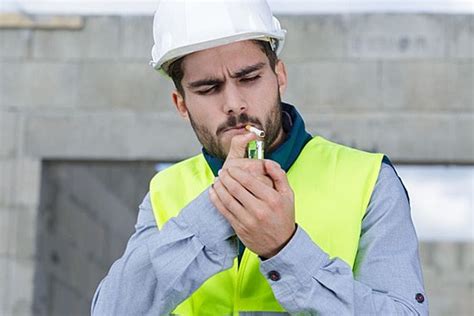 Smoking Cigarette On Construction Site Photo Background And Picture For