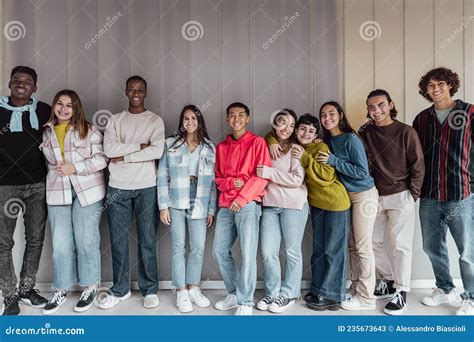 Happy Multiracial Group Of Teenagers Having Fun Inside University Stock