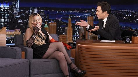 madonna climbs on jimmy fallon s desk and flashes audience during tonight show appearance