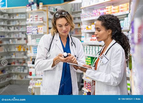 Two Pharmacists Working Together At Pharmacy Stock Image Image Of