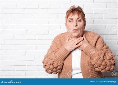 Elderly Woman Coughing Near Brick Wall Stock Image Image Of Allergy