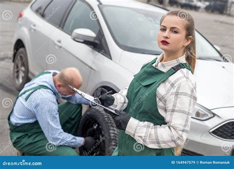 Woman Inspecting How Mechanic Fixing Car Wheel Stock Image Image Of