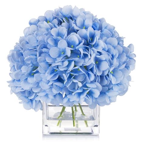 A Vase Filled With Blue Flowers On Top Of A Table