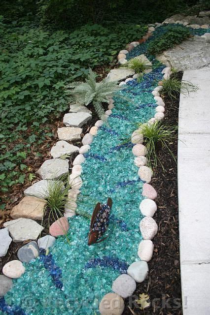 There Is A Small Stream Made Out Of Rocks And Glass Pebbles In The