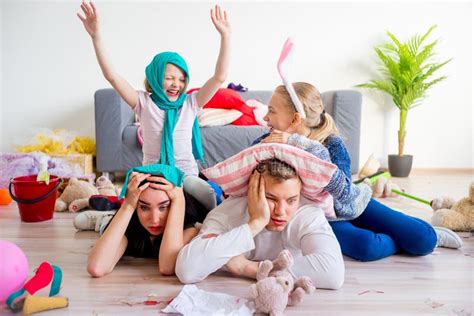 Tired Parents And Romping Kids Stock Photo Image Of Fooling Home
