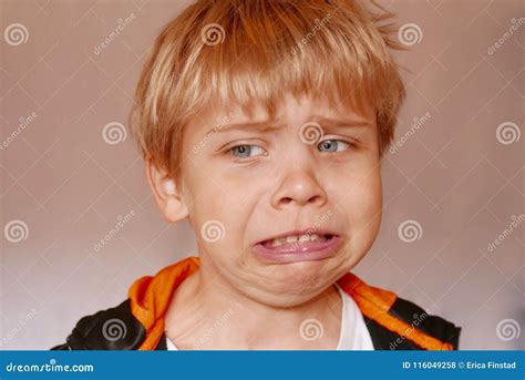 Close Up Of Boy Making A Disgusted Facial Expression Stock Photo