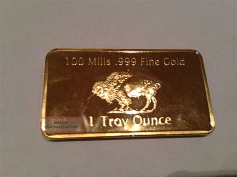 (the spot price is how much one troy ounce of gold costs and is determined by the market.) Gold Plated Bar 1 Ounce ' American Buffalo ' 100 Mills. 999 24k 1 Oz Fine Bullion