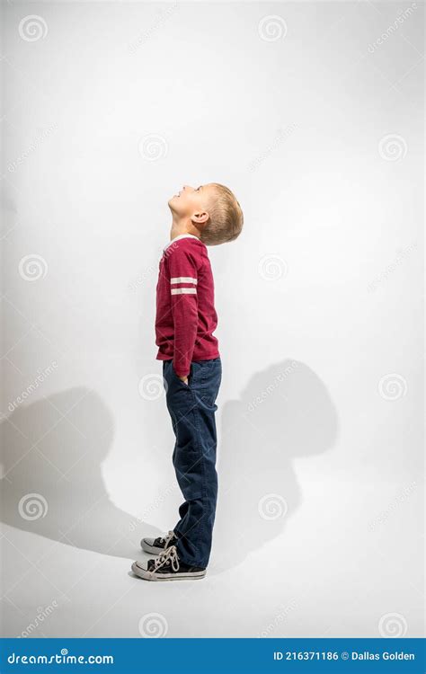 Little Boy Standing Sideways And Looking Up Stock Photo Image Of