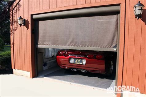 A Red Car Is Parked In The Garage With Its Door Open And Its Hood Up