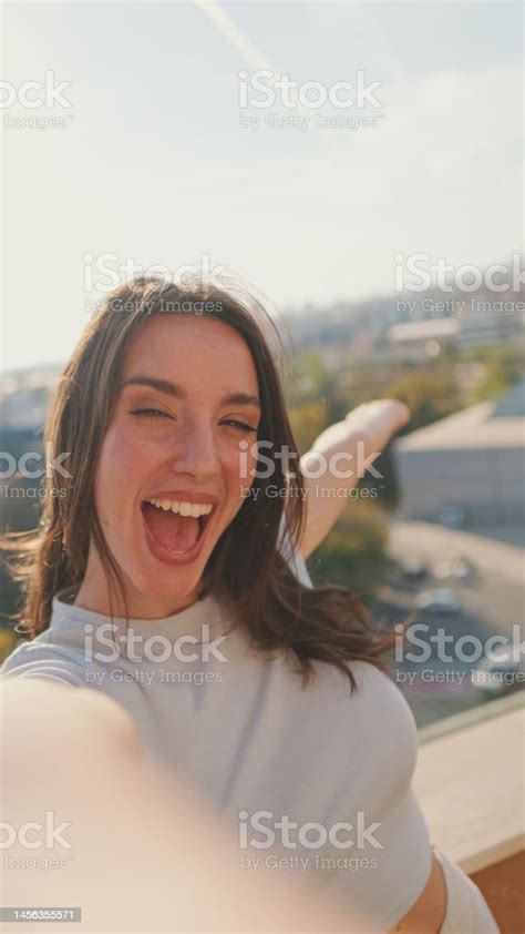 Closeup Of Young Woman Taking Selfie Hand Peace Sign While Standing On