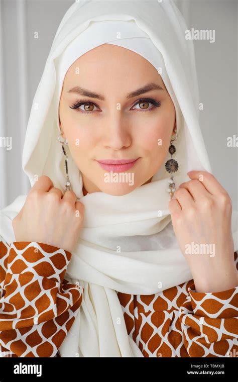 Portrait Of Beautiful Young Muslim Arabian Woman Wearing White Hijab Looking At Camera Close Up