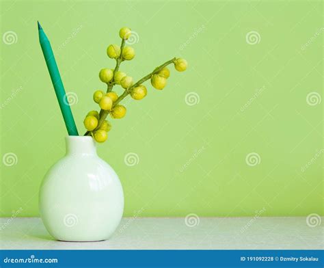 Pencil And Flower In A Vase On A Green Pyspace For Text