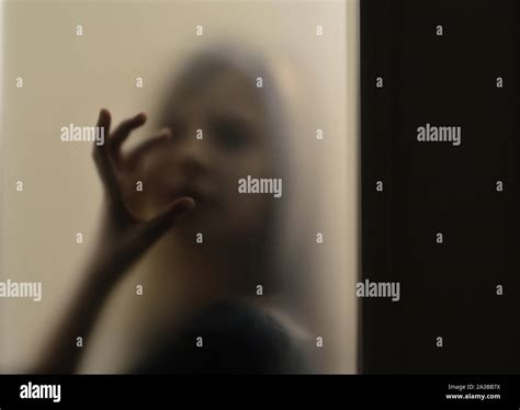 Girl Behind Frosted Glass Stock Photo Alamy