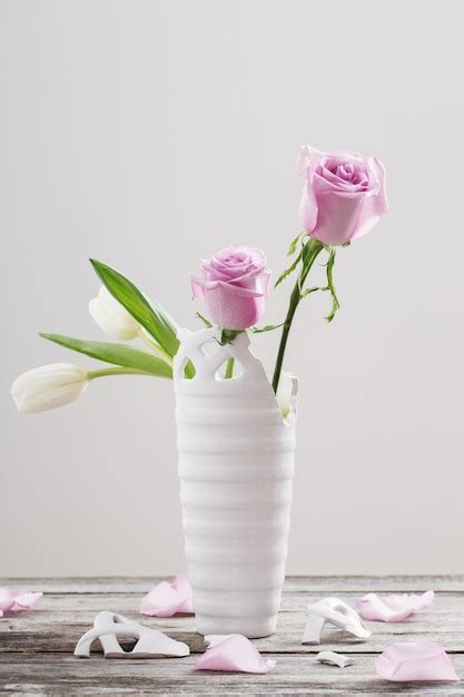 Premium Photo Pink Roses In Broken Vase On Old Wooden Table