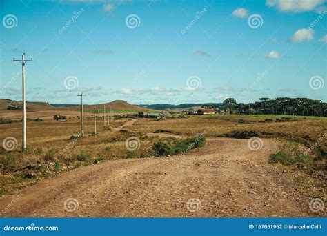 Dirt Road Passing Through Rural Lowlands And Ranch Stock Photo Image